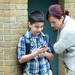 Fifth-grader Danny Taymour, 10, shows his mom Sarah something on his iPhone as they wait for the first day of school to begin at Logan Elementary School on Tuesday, September 3, 2013. Melanie Maxwell | AnnArbor.com